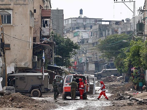 Israeli security forces stop and search a Palestinian Red Crescent ambulance at the entrance to the Tulkarem refugee camp in the occupied West Bank during a raid on January 17, 2024.