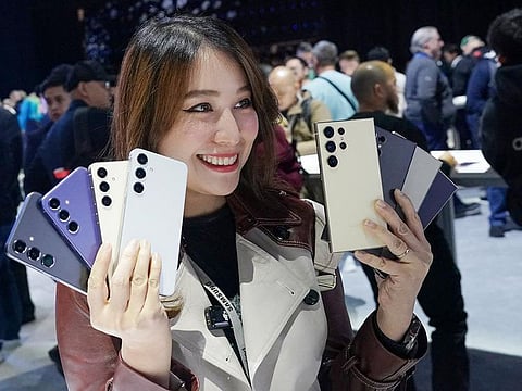 An influencer poses with Samsung’s new line of Galaxy S24 model phones offering AI functions at the Galaxy Unpacked event in San Jose, California, on January 17, 2024.