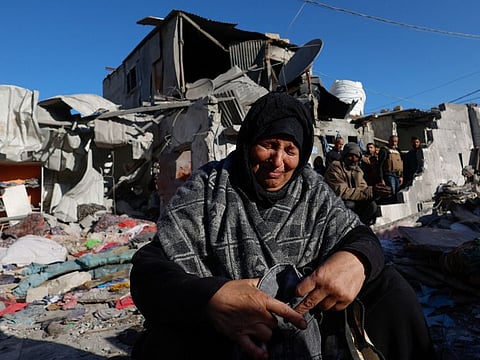 A Palestinian woman is at the site of an Israeli strike on a house in Rafah in the southern Gaza Strip, on January 18, 2024.