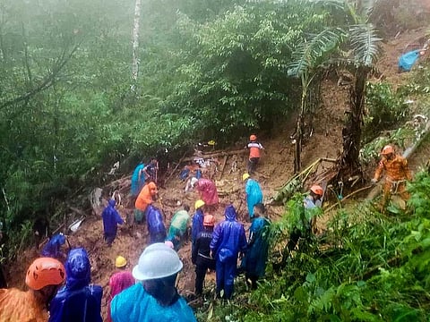 This photo released by the Municipality of Monkayo shows rescuers conducting a rescue and retrieval operation, a day after a landslide hit a house in Monkayo.