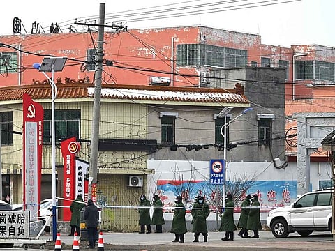 Police stand outside a school where 13 people died in a fire in Yanshanpu, in China’s central Henan province on January 21, 2024.