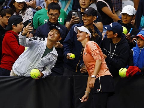 Czech Republic's Barbora Krejcikova poses for a selfie with fans after winning her fourth round match against Russia's Mirra Andreeva on Sunday.
