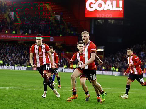 Sheffield United's Oli McBurnie celebrates scoring their second goal with Anel Ahmedhodzic and James McAtee during a Premier League match against West Ham United at Bramall Lane on Sunday.