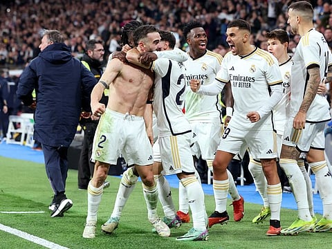 Real Madrid's Dani Carvajal celebrates scoring their third goal with teammates during a La Liga match against Almeria.
