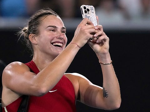 Aryna Sabalenka of Belarus takes a selfie on a mobile phone after defeating Amanda Anisimova of the US in their fourth round match at the Australian Open at Melbourne Park on Sunday.