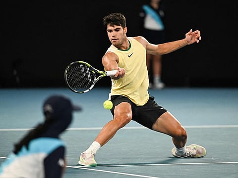 Spain's Carlos Alcaraz hits a return against Serbia's Miomir Kecmanovic during their men's singles match on day nine of the Australian Open in Melbourne on Monday.