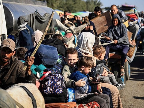 This photograph taken on January 22, 2024 on the southern outskirts of Khan Younis, in the southern Gaza Strip, shows Palestinian families fleeing the city on the coastal road leading to Rafah, amid ongoing battles between Israel and the Palestinian militant group Hamas.