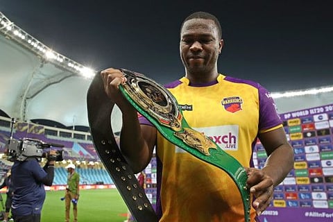 Johnson Charles of Sharjah Warriors with the greenbelt for scoring the highest number of runs in the tournament so far.