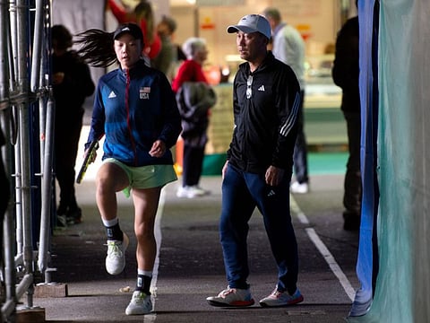 Former US tennis player Michael Chang (right) stands by his daughter Lani Chang, as she takes part in "Les petits As" tournament in Tarbes, southwestern France.