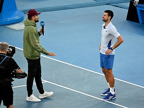 Serbia's Novak Djokovic is interviewed by Australia's Nick Kyrgios after winning his quarter-final match against Taylor Fritz.