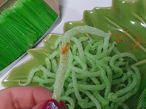 A person holds a "Fried green toothpick" which went viral following a social media trend.