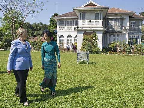 Myanmar's pro-democracy opposition leader Aung San Suu Kyi, right, and U.S. Secretary of State Hillary Rodham Clinton walk through the garden after meetings at Suu Kyi's residence in Yangon, Myanmar on Dec. 2, 2011.