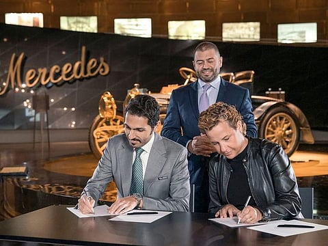 Muhammad Binghatti, CEO, Binghatti Properties and Britta Seeger, Member of the Board of Management of Mercedes-Benz Group AG, Marketing & Sales, sign the agreement.