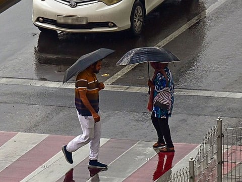 Residents caught in the rain at Al Majaz in Sharjah.
