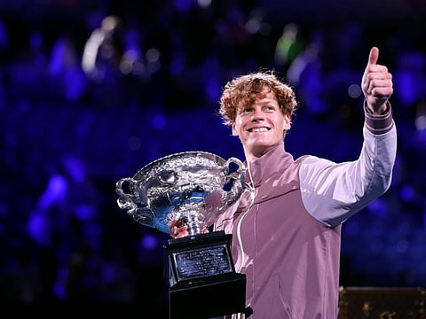 Italy's Jannik Sinner celebrates with the Norman Brookes Challenge Cup trophy after defeating Russia's Daniil Medvedev in the men's singles final match on day 15 of the Australian Open tennis tournament in Melbourne on January 28, 2024. (Photo by Martin KEEP / AFP) / -- IMAGE RESTRICTED TO EDITORIAL USE - STRICTLY NO COMMERCIAL USE --