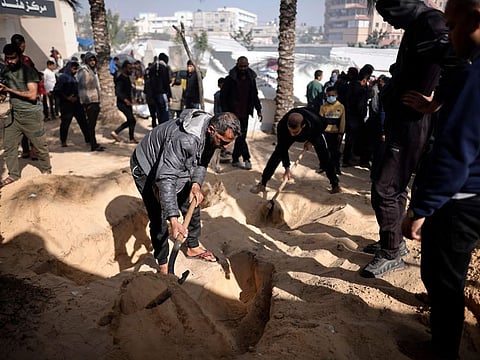 Palestinians dig graves to bury their relatives who were killed in the Israeli bombardment of the Gaza Strip, at the Nasser hospital in Khan Younis, Southern Gaza Strip.
