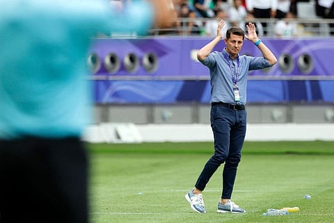 Iraq's Spanish coach Jesus Casas gestures to his players from the touchline during the Qatar 2023 AFC Asian Cup match against Jordan.
