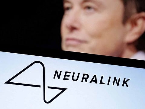 Neuralink logo and Elon Musk photo are seen in this illustration