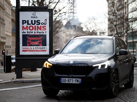 A poster reading "More or less SUVs in Paris? Vote on February 4" is on a billboard in a street as Parisians vote in a referendum.