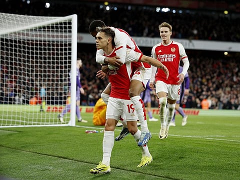 Arsenal's Leandro Trossard celebrates scoring their third goal with Reiss Nelson during a Premier League match against Liverpool at Emirates Stadium, London, on Sunday.