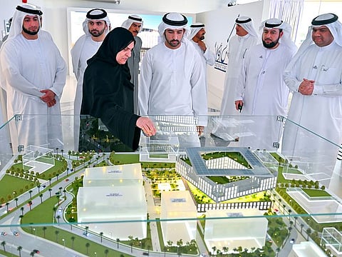 Sheikh Hamdan bin Mohammed bin Rashid Al Maktoum (centre front), Crown Prince of Dubai and Chairman of The Executive Council of Dubai, next to a model of the upcoming Hospital