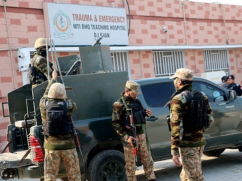 Security personnel stand guard outside a hospital where injured police officers are treated after a militant attack on a police station in Dera Ismail Khan, on February 5, 2024.
