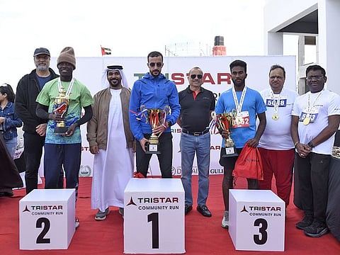 Tristar Group CEO Eugene Mayne, fourth from right, with the winners in the 10km male category, along with Gulf News COO Marclino Fernandes (left), Tristar Group Chief Administrative Officer Balaji Nagabhushan (second from right), Team Sports UAE Managing Director Khalifa Al Shamsi (third from left), and Emrill Group COO Gopalakrishnan (right)