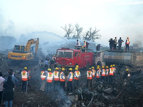 Rescue members from State Disaster Response Force (SDRF) douse the smoldering debris following a blast in a firecracker factory in Harda, Madhya Pradesh, India, February 6, 2024.