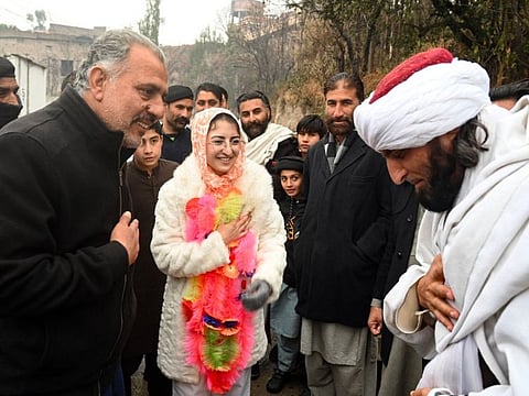 Saveera Parkash, a Hindu minority candidate of the Pakistan Peoples Party (PPP) for provincial assembly, greeting mufti Fazal Ghafoor, candidate of the Jamiat Ulema Islam-Fazal (JUI-F) party, during her election campaign rally in the Buner district of Khyber Pakhtunkhwa province.