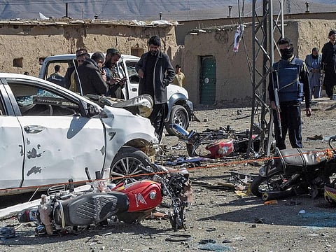 Security personnel inspect the site of a bomb blast outside the office of an independent candidate in Pishin district, around 50 kilometres (30 miles) from Quetta on February 7, 2024.