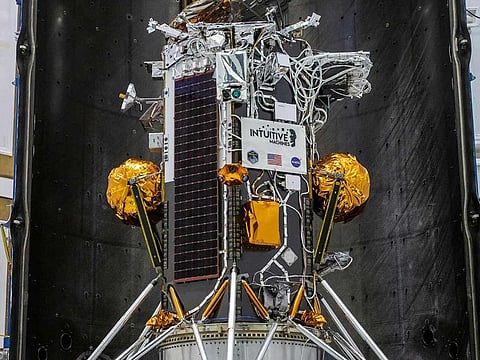 The photo shows the Nova-C lunar lander encapsulated within the fairing of a SpaceX Falcon 9 rocket in preparation for launch, as part of NASA’s CLPS (Commercial Lunar Payload Services) initiative and Artemis campaign in Kennedy Space Center, Florida.