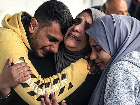 Palestinians mourn after identifying corpses of relatives killed in overnight Israeli bombardment on the southern Gaza Strip at Al Najjar hospital in Rafah on February 8, 2024.