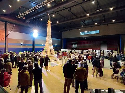 Richard Plaud, a Frenchman who built a model of the Eiffel Tower using 706,900 matchsticks poses next to the structure measures at 7.19 m in this undated photograph taken in Saujon, France, January 7, 2024.