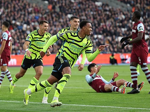 Arsenal's Brazilian defender Gabriel Magalhaes (centre) celebrates with teammates after scoring their third goal against West Ham United during the English Premier League match at the London Stadium on Sunday.