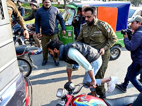 Police detain the supporters of Khan's Pakistan Tehreek-e-Insaf (PTI) party as they protest against the alleged skewing in Pakistan's national election results, near the office of a Returning Officer in Lahore on February 11, 2024.