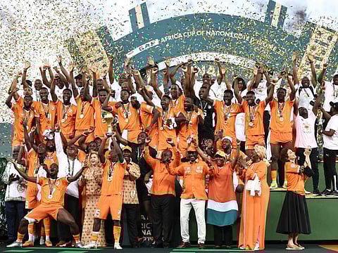 Ivory Coast's forward Max-Alain Gradel lifts the Africa Cup of Nations trophy on the podium after winning the Africa Cup of Nations at Alassane Ouattara Olympic Stadium in Ebimpe, Abidjan on Sunday.