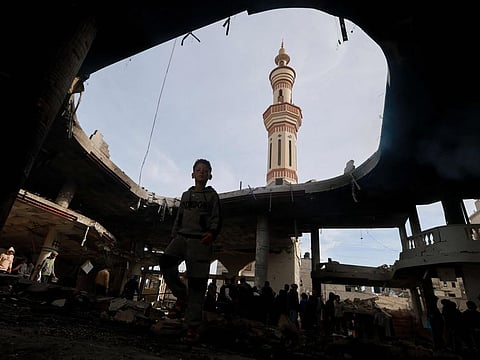 People inspect the damage in the rubble of a mosque following Israeli bombardment, in Rafah, in the southern Gaza Strip on February 12, 2024.
