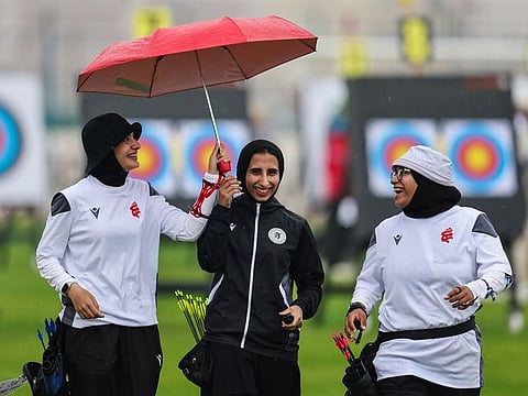 Archers enjoy a moment during rains at Arab Women's Sports Tournament in Sharjah.