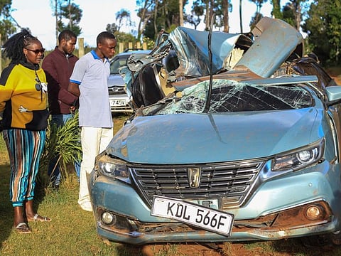 Members of the public look at the wreckage of the car in which Kelvin Kiptum and his coach Gervais Hakizimana were traveling before the crash near Eldoret town on February 12.