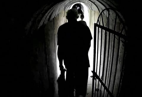 This image grab from a handout video released by the Israeli army on February 13, 2024, shows what the army says is Hamas's chief in Gaza Yahya Sinwar walking in a tunnel along with other people, in the Gaza Strip amid ongoing battles between Israel and the Palestinian militant group Hamas.