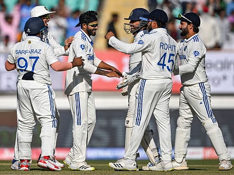 India's Ravindra Jadeja (3L) celebrates with teammates after the dismissal of England's Ben Foakes during the fourth day of the third Test cricket match at the Niranjan Shah Stadium in Rajkot on Sunday.