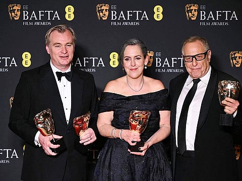 US film producer Charles Roven (R), British film producer Emma Thomas (C) and British film producer and director Christopher Nolan (L), who also won Best Director Award, pose with the award for Best film for "Oppenheimer" during the BAFTA British Academy Film Awards ceremony at the Royal Festival Hall, Southbank Centrer, in London, on February 18, 2024.