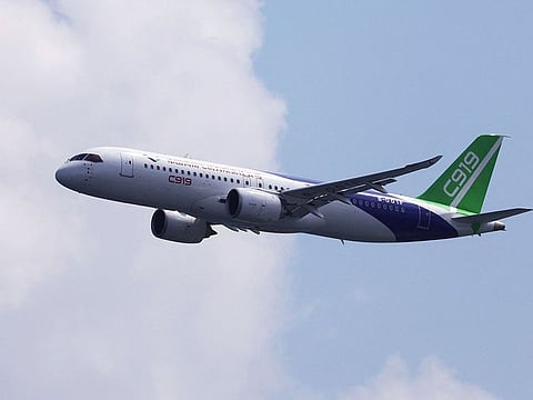 A Comac C919 flies past during an aerial flying display.