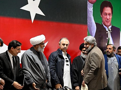 Omar Ayub Khan (4rth left), nominee for prime minister from Pakistan Tehreek-e-Insaaf (PTI) party, Gohar Ali Khan (second left) PTI's chairman and barrister speak with Sahibzada Muhammad Hamid Raza (third right), leader of the political group Sunni Ittehad Council during press conference following their coalition in Islamabad on February 19, 2024.