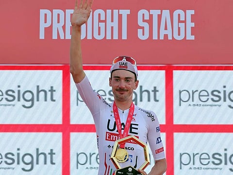 UAE Team Emirates' Brandon Mcnulty waves from the podium after he won the second stage of the 6th UAE Cycling Tour on Tuesday.