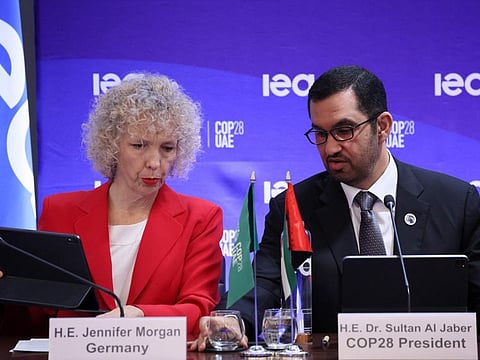 COP28 president Sultan Ahmed Al Jaber talks to State secretary and special envoy for intenational climate action German Jennifer Morgan during a high-level round table on COP energy and climate commitments organised by the International Energy Agency (IEA) at its headquarters in Paris on February 20, 2024.