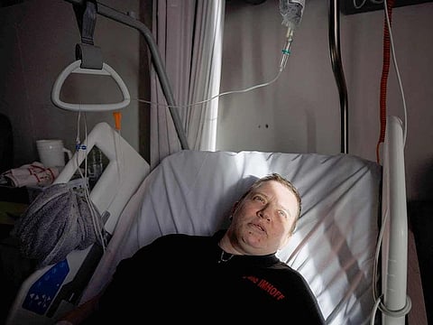 Lydie Imhoff lies on her bed in a hospital room in Belgium, on February 1, 2024 as she waits for the doctor to arrive on the day of the euthanasia. Lydie Imhoff, a 43 year-old French citizen suffering from hemiplegia and blindness from birth due to a perinatal stroke, has been authorised to travel from Besancon, France, to Belgium to undergo euthanasia on February 1, 2024.