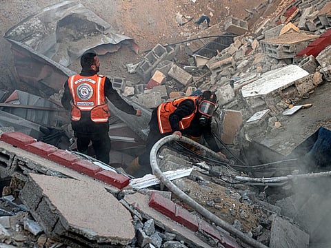 Members of the Palestinian civil defence extinguish a fire in a building following Israeli bombardments east of Rafah in the southern Gaza Strip on February 19, 2024, amid continuing battles between Israel and the Palestinian militant group Hamas. (Photo by SAID KHATIB / AFP)