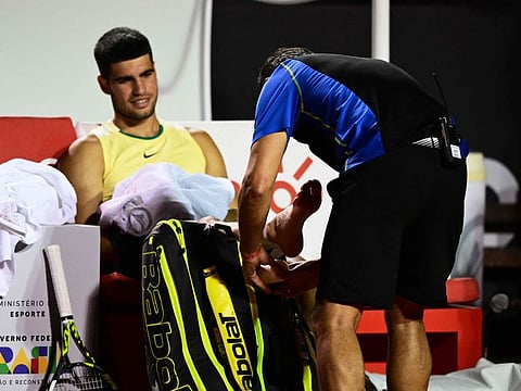Spain's Carlos Alcaraz gestures after suffering an injury during the ATP 500 Rio Open match against Brazil's Carlos Monteiro in Rio de Janeiro, Brazil on Tuesday.