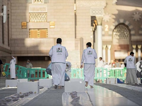 Workers at the Grand Mosque in Makkah prepare iftar spreads for visitors before sunset, in this file picture.
